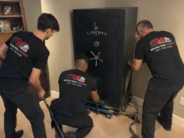 Gun safe movers taking a heavy safe up stairs in Portland, Oregon
