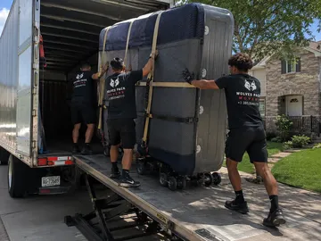 Hot tub strapped upright on a truck lift gate — hot tub relocation service Seattle