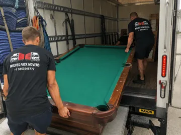 Loading pool table into moving truck by Utah movers